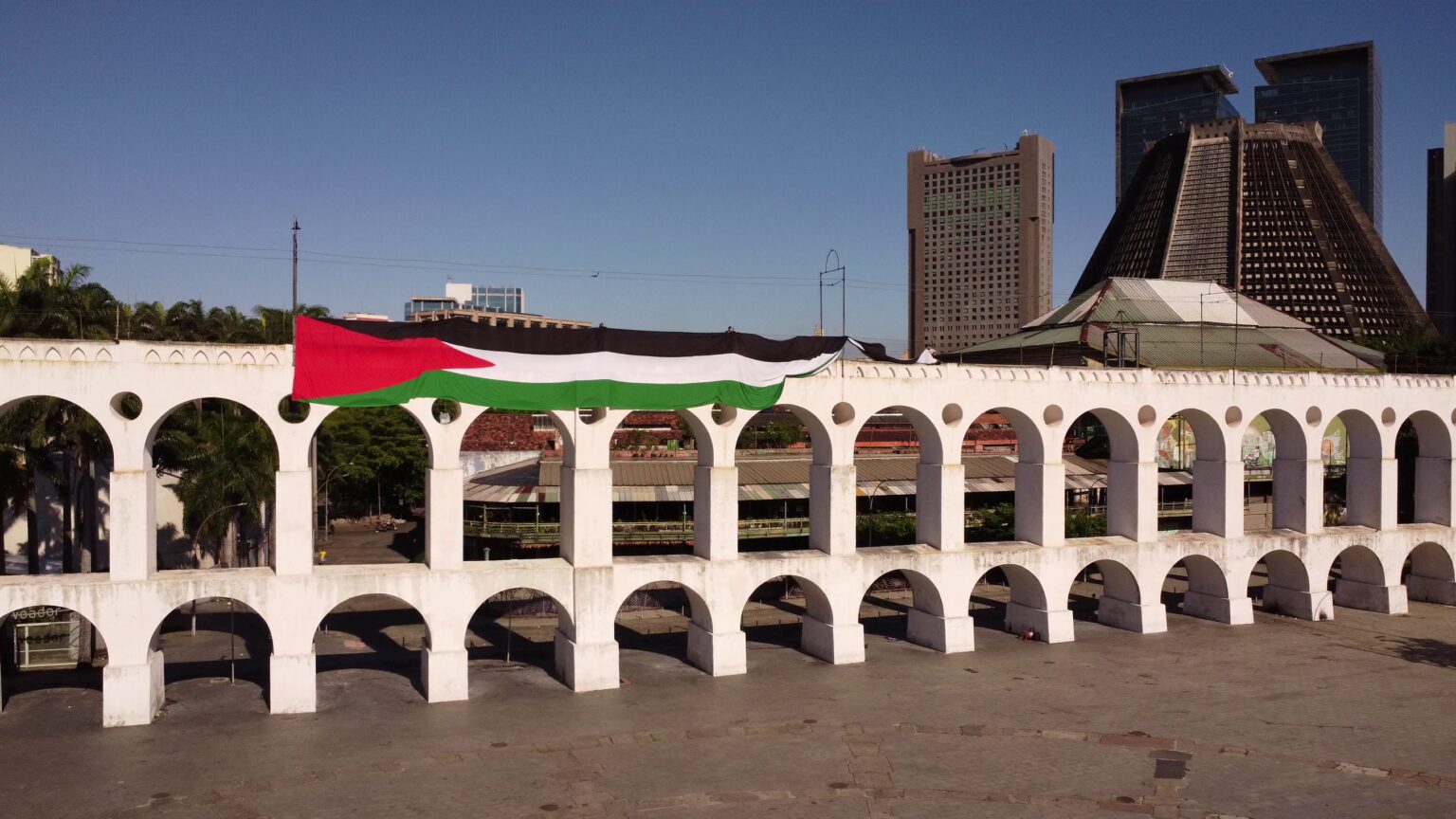 a Palestinian flag draped from the Arcos da Lapa in Rio de Janeiro